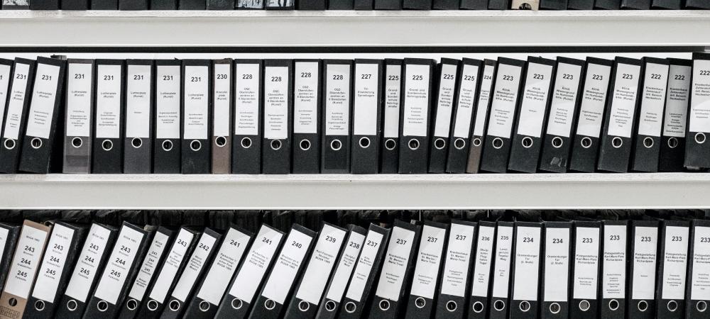 A shelf full of archived binders.